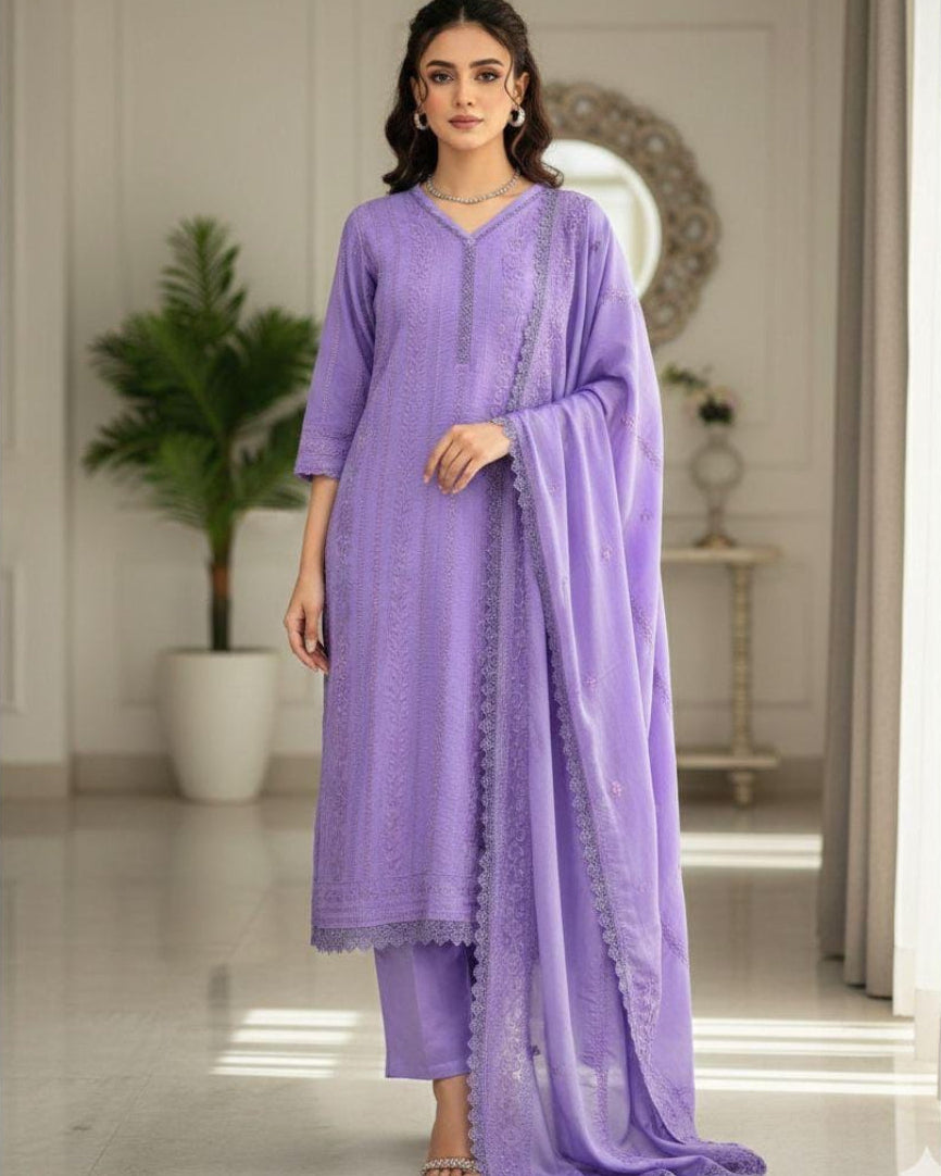 Woman wearing a purple traditional outfit with a matching dupatta in an indoor setting.